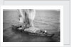Indigenous boat at sea, laden with sacks by unknown
