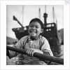 A portrait of a young girl in a sampan in Aberdeen harbour, Hong Kong. by David Watkin Waters