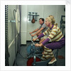 After all the lunches and cocktail evenings, a little exercise is just the thing: two passengers use exercise bikes in the gym of an unspecified cruise liner by Marine Photo Service