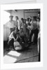 A group of off-duty crew from 'Carinthia' (1925) pose with a captured shark on deck by Marine Photo Service