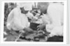 Pearl buyers examining pearls by Alan Villiers