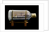 A bottle containing a model ship by unknown