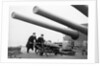 Two ratings pushing a 14-inch shell on a trolley on the battleship 'King George V' (1939). King George V carried about 800 shells for her 10 guns when loaded. by unknown