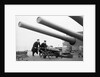 Two ratings pushing a 14-inch shell on a trolley on the battleship 'King George V' (1939). King George V carried about 800 shells for her 10 guns when loaded. by unknown