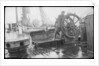 The 'Herzogin Cecile' (Fi, 1902) a seaman at the midships wheel in heavy weather. The helmsman is wearing a safety harness by unknown