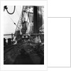 One of the crew on the forecastle head capstan by Alan Villiers