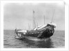 A baggala at anchor off Zanzibar discharging her cargo by Alan Villiers
