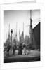 Men and women onlookers at the end of the quay looking at the forest of masts and sails in the harbour at Lowestoft, Suffolk by Smiths Suitall Ltd.
