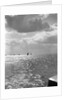 The sunlit North Sea from the harbour entrance with a number of trawlers under sail on the horizon at Lowestoft, Suffolk by Smiths Suitall Ltd.