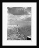 The sunlit North Sea from the harbour entrance with a number of trawlers under sail on the horizon at Lowestoft, Suffolk by Smiths Suitall Ltd.