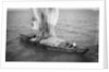 Indigenous boat at sea, laden with sacks by unknown