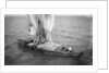 Indigenous boat at sea, laden with sacks by unknown