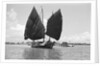 A bell stemmed harbour junk under sail at Singapore by David Watkin Waters
