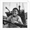 A portrait of a young girl in a sampan in Aberdeen harbour, Hong Kong. by David Watkin Waters