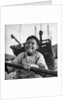 A portrait of a young girl in a sampan in Aberdeen harbour, Hong Kong. by David Watkin Waters