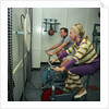 After all the lunches and cocktail evenings, a little exercise is just the thing: two passengers use exercise bikes in the gym of an unspecified cruise liner by Marine Photo Service