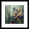 After all the lunches and cocktail evenings, a little exercise is just the thing: two passengers use exercise bikes in the gym of an unspecified cruise liner by Marine Photo Service