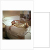 Modern convenience aboard a cruise liner: a female passenger reclines in bed whilst making a phone call; the ship and the conversation's content are unspecified by Marine Photo Service