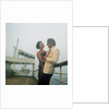 A misty evening offers amorous opportunities on deck for a romantic, smartly dressed, couple on a cruise ship by Marine Photo Service
