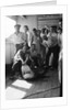 A group of off-duty crew from 'Carinthia' (1925) pose with a captured shark on deck by Marine Photo Service