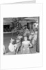 Three children in the "Apple Eating" contest, possibly in the ballroom of the 'Chusan' (1950) by Marine Photo Service