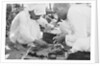 Pearl buyers examining pearls by Alan Villiers
