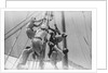 Sailors climbing the halyard blocks by Alan Villiers