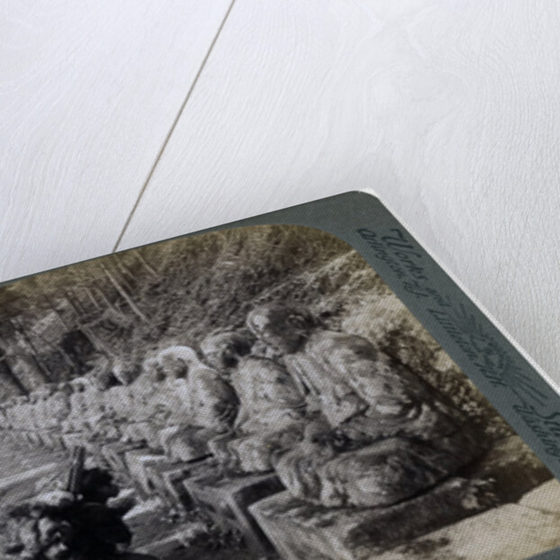 Peasant praying before a row of statues of the God of Light, Daiya river, Nikko, Japan by Underwood & Underwood
