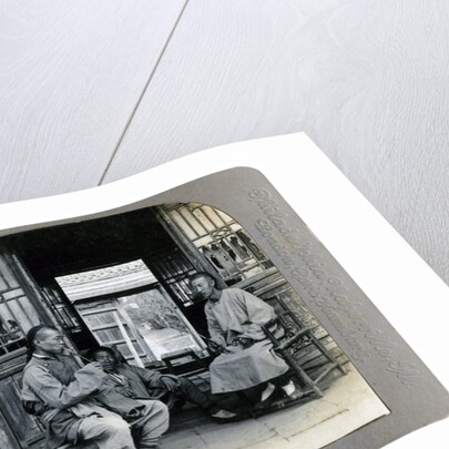 A social hour, a typical Chinaman smoking, China by CH Graves