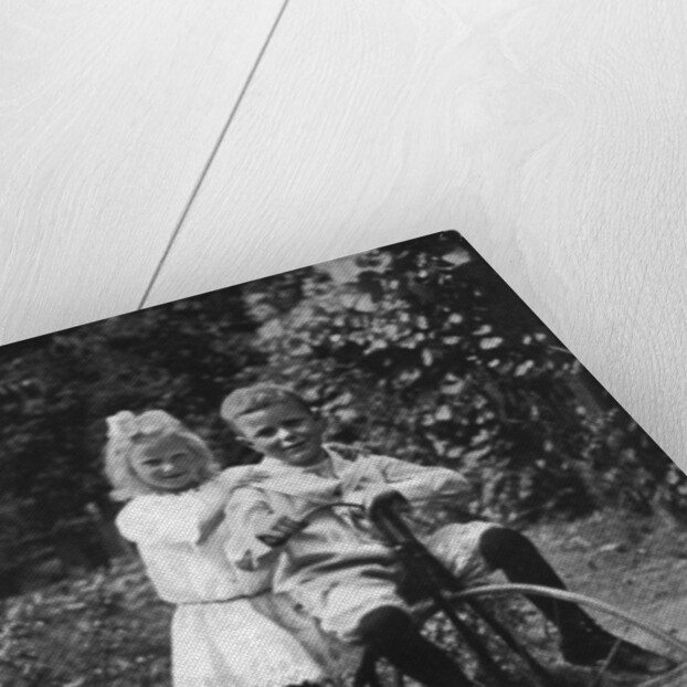 Two children on a tricycle by CW Perry