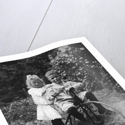 Two children on a tricycle by CW Perry