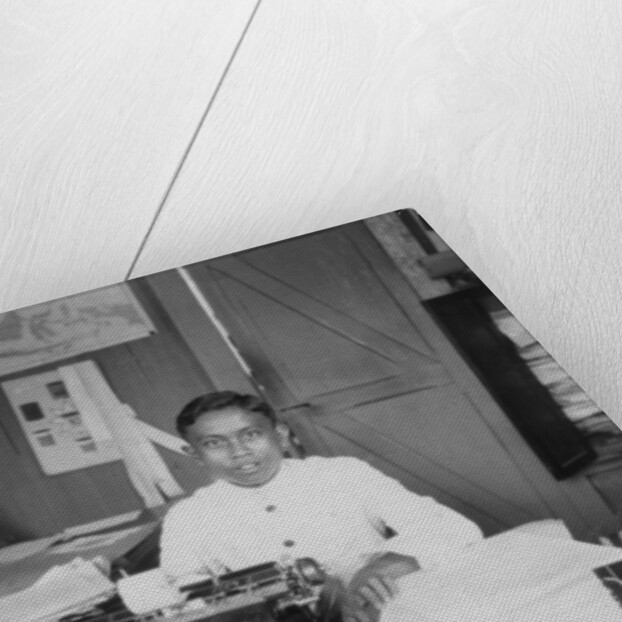A young man sitting at a typewriter, Indonesia by Anonymous