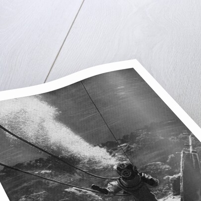 The first photograph of a diver under water by Anonymous