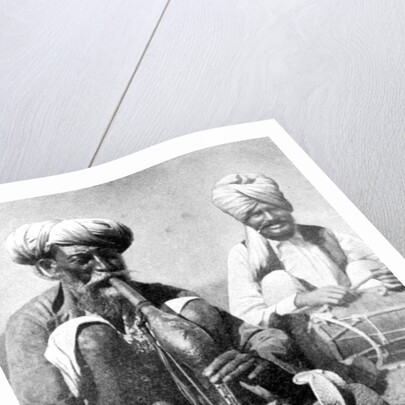 Charming the venom from a cobra; a snake charmer with a mongoose, India by JH Powell