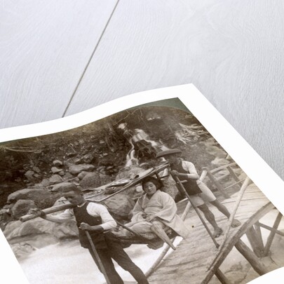 Japanese woman in a yamakago (mountain chair) crossing the torrential Daiya river near Nikko, Japan by Underwood & Underwood