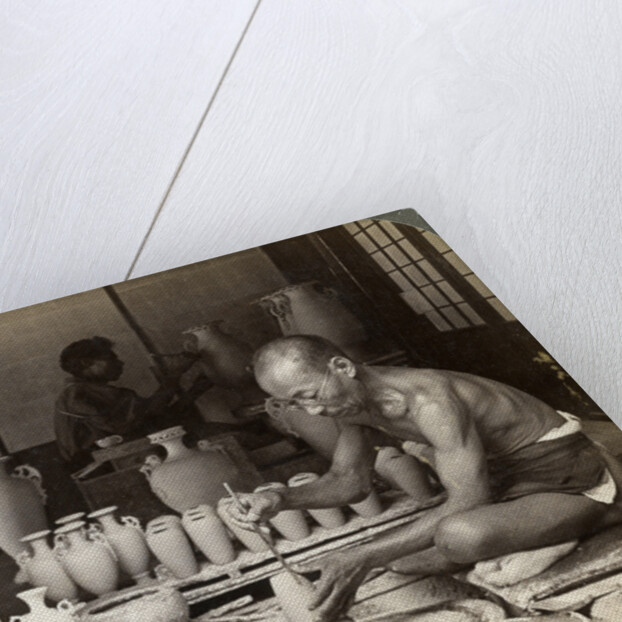 A potter and his wheel, fashioning a vase of Awata porcelain, Kinkosan works, Kyoto, Japan by Underwood & Underwood