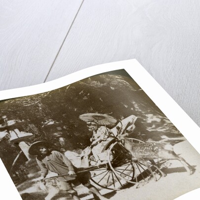 Girl feeding sacred deer on her way to prayers, grounds of Kasuga Temple, Nara, Japan by Underwood & Underwood