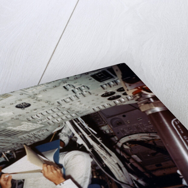 An astronaut inside a NASA Command Module by NASA