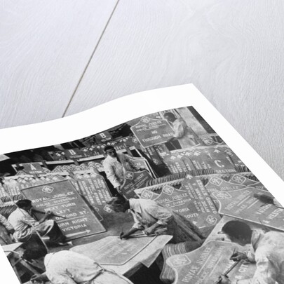 Men in the RAC Highways Department preparing traffic signs by Anonymous