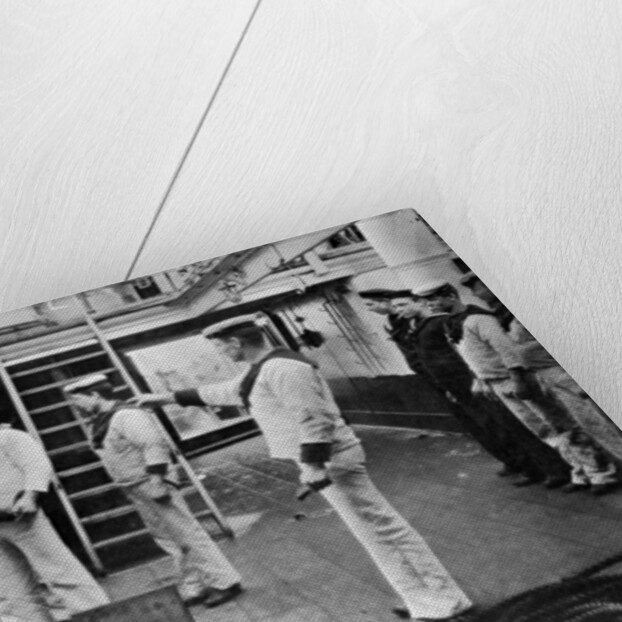 At drill with a 6 inch quick firing gun on board the battleship HMS Resolution by Gregory & Co