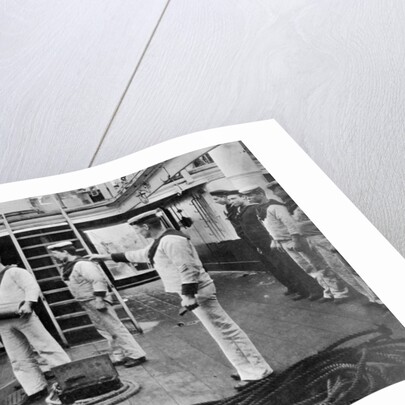 At drill with a 6 inch quick firing gun on board the battleship HMS Resolution by Gregory & Co