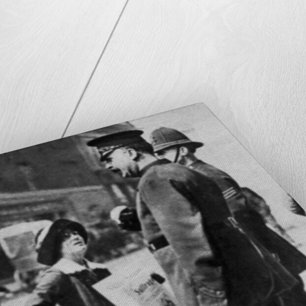 A suffragette confronting two policemen by Sport & General