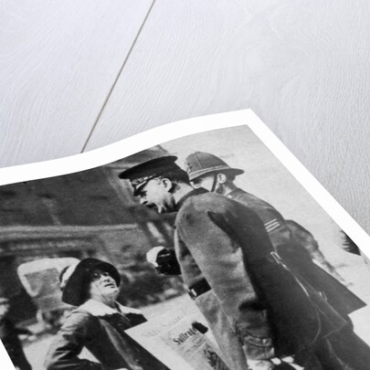 A suffragette confronting two policemen by Sport & General