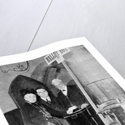 A woman recording her vote at the ballot box by Anonymous
