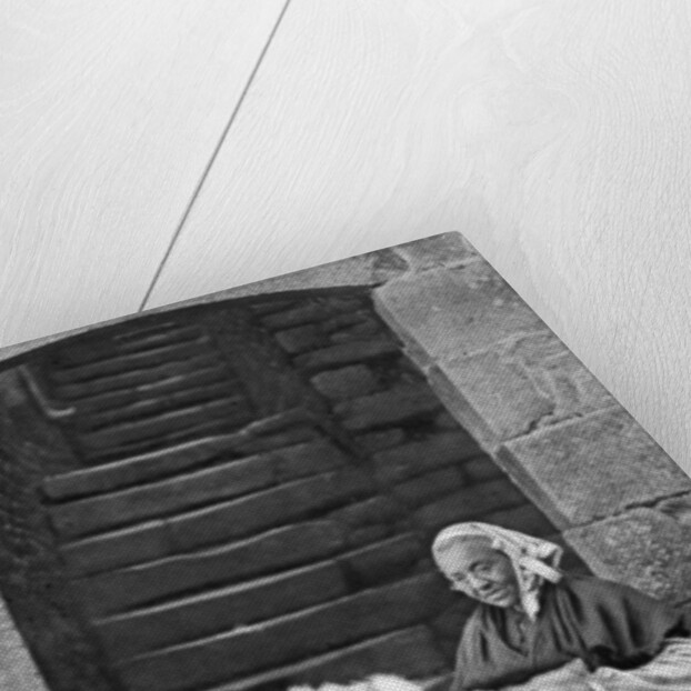 A woman at a spinning wheel, Dinan, Brittany, France by Anonymous