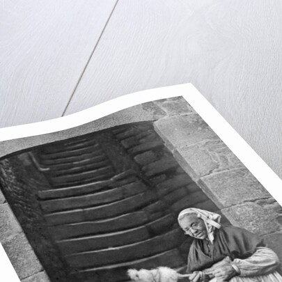A woman at a spinning wheel, Dinan, Brittany, France by Anonymous