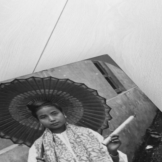 Young Burmese woman holding a huge cigar, Rangoon, Burma by Stereo Travel Co