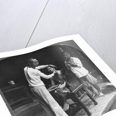 A Chinese barber at Bhamo, Burma by Stereo Travel Co