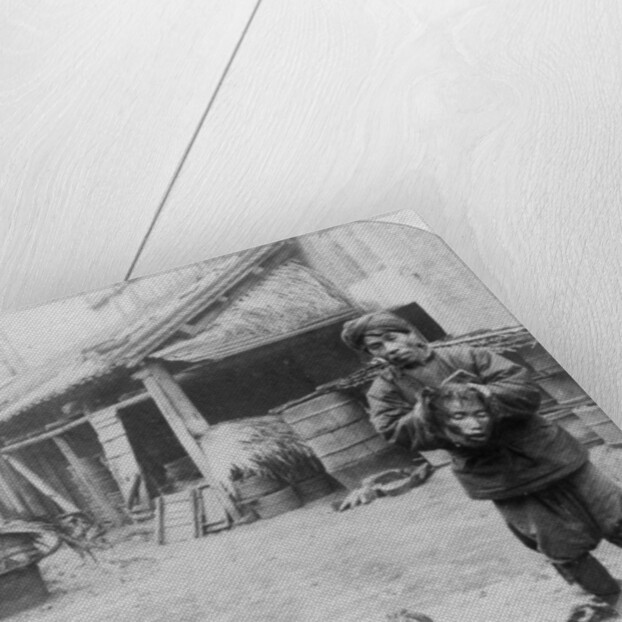 The grim executioner taking the labled head to exhibit a warning by Underwood & Underwood