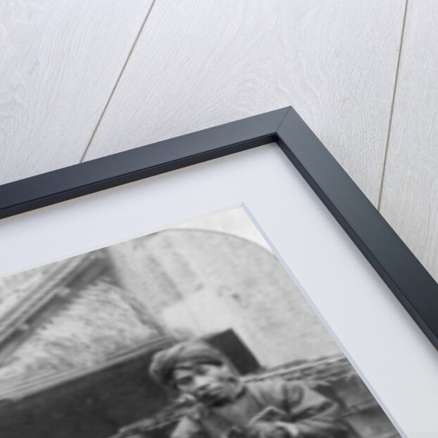 The grim executioner taking the labled head to exhibit a warning by Underwood & Underwood